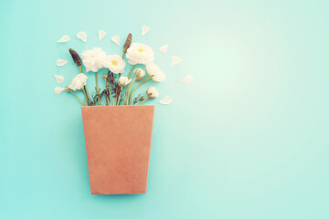 Top view image of white flowers composition over blue pastel background - obrazy, fototapety, plakaty