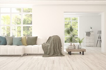 Fototapeta premium Mock up of minimalist living room in white color with sofa. Scandinavian interior design. 3D illustration