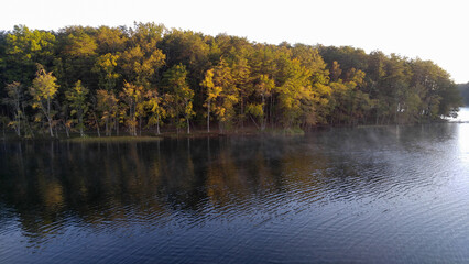 Fototapeta na wymiar Lake with a tree lined bank