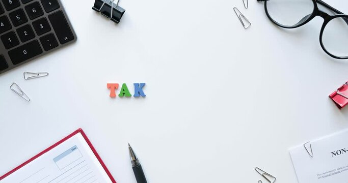 Flatlay with office items and phrase Take a break from colored wooden letters. Layout on a white background. Glasses, keyboard, pen, paper clips, diary, work papers. 4K looped stop motion animation