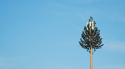 Fototapeta na wymiar gsm antennas positioned on a pole arranged to look like a fir tree.