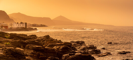View of rocky coastline and Atlantic sea at sunset near El Pagador, Las Palmas, Gran Canaria, Canary Islands