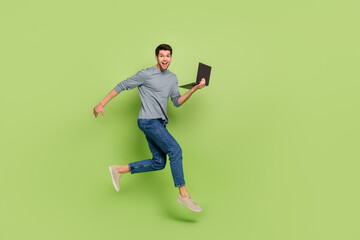 Full size photo of running brown haired casual style businessman rush to complete his task isolated on green color background