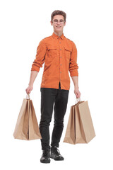 Full length portrait of a young casual man holding shopping bags