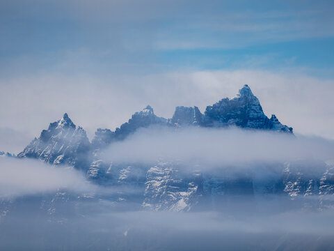 Fog obscures the rugged mountains and glaciers of the south side of the South Georgia coastline, South Georgia