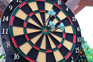 Colorful arrows hit the dartboard, hit right on target, electronic scoreboard counts the players'...