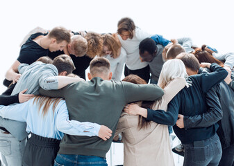 group of young like-minded people standing in a circle.