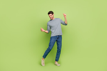 Full length image of cheerful male have fun dancing spend summer vacation isolatedo n green color...