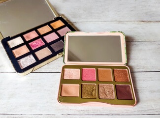 Nude eye shadow palette on wooden background 
