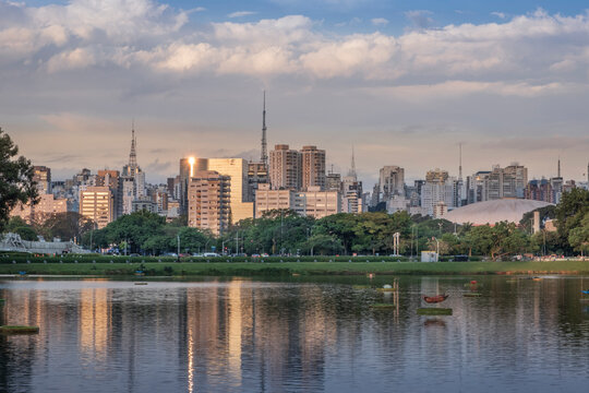 The downtown urban skyline reflected in Lago das Garcas lake at twilight, Ibirapuera Park, Sao Paulo
