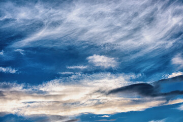 A bright sunset on the background of cloudy sky.