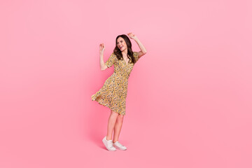 Full size portrait of overjoyed satisfied lady raise arms spend pastime isolated on pink color...