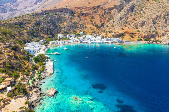 Aerial view of traditional whitewashed buildings of Loutro village and transparent sea, Crete island, Greek Islands