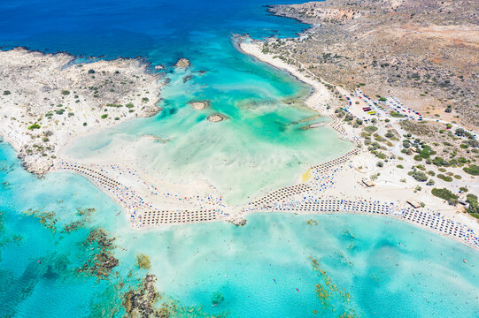 Aerial view of the equipped Elafonissi beach set in the unspoiled turquoise lagoon, Crete island, Greek Islands