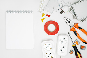white blank space, notebook and electrical tools and equipment, top view.