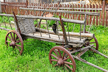 Fototapeta premium Old wooden cart parked in garden