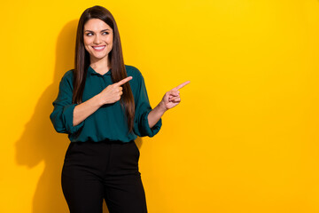 Photo of dreamy pretty woman wear green shirt pointing looking empty space isolated yellow color background