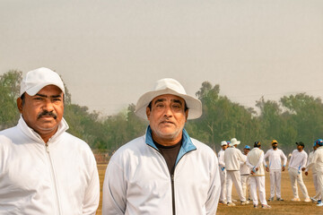 cricket match umpire and couch in match ground