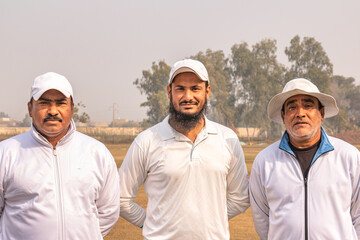 cricket players get to pose with the team couch and the umpire