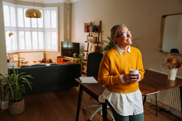 Young caucasian woman standing in living room 