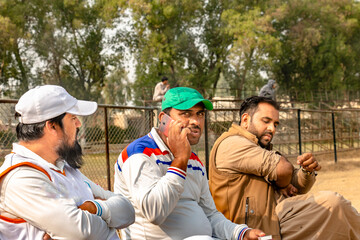 cricket coach looking to the cricket players' team 