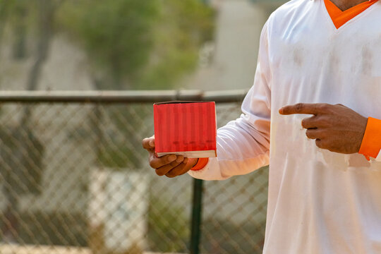 Young Cricketer Showing Hand On Empty Box On Match Ground