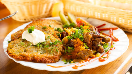 belarusian draniki with grilled beef dish in a restaurant