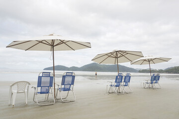Set of Sun Chairs and Parasol on the Beach. Calm Cloud Summer Day.