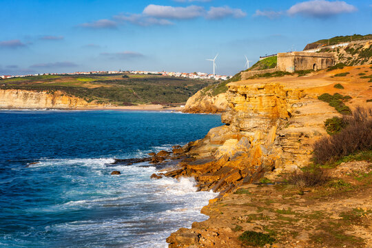 Milreu fortress on the cliff and Ribeira d'ilhas beach in Ericeira, Portugal