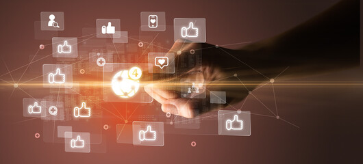 Hand pressing social media multimedia application screen with media icons on futuristic concept