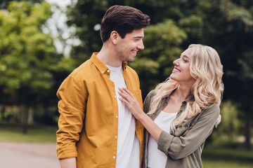 Fototapeta premium Portrait of attractive cheerful adorable couple friends friendship spending free time hugging on fresh air outdoors