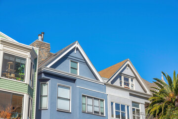 Townhouses with gable roofs against the clear sky in San Francisco, California