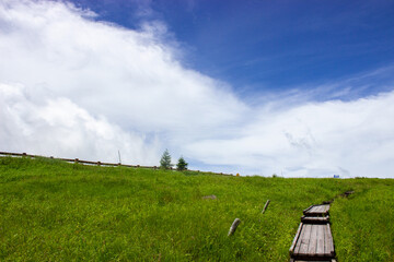 Pasture on the plateau with clouds in the background