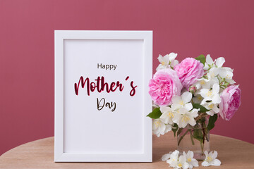 Happy Mothers Day greeting text in white frame with flowers