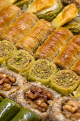 Mixed baklava. Pistachio and walnut baklava. Close-up of baklava in a tray. Selective focus