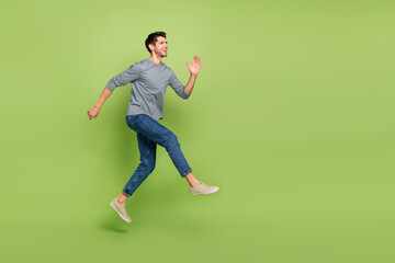 Fototapeta na wymiar Full body photo of overjoyed emotion attractive guy excited to go on date with girlfriend isolated on green color background