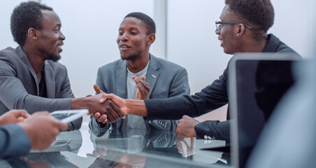business partners greeting each other with a handshake.