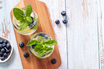Blackberry and lemon refreshing summer cocktail with berries and citrus fruit