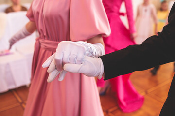 Couples dance on the historical costumed ball in historical dresses, classical ballroom dancers dancing, waltz, quadrille and polonaise in palace interiors on a wooden floor, opera gloves close-up - obrazy, fototapety, plakaty