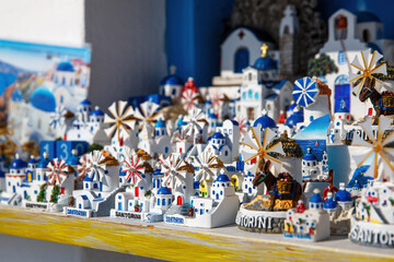Windmills and churches - souvenirs on Santorini island, Greece.