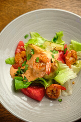 Grilled spicy lamb and salad wrapped in flatbread, with tomatoes