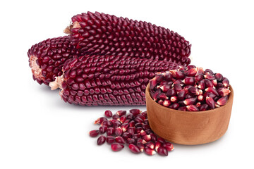 Purple corn seeds in wooden bowl isolated on white background with full depth of field