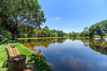 Fishing lake with calm water and green trees around. Concept of a peaceful place to live during retirement, and a eco lifestyle next to the nature. 