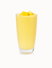 Fresh Mango ripe organic yellow smoothie honey mix in glass. Garnish isolated on white background. Ripe mangoes are popular all over world. Perfect for summer drink. Healthy food. There is vitamin C.