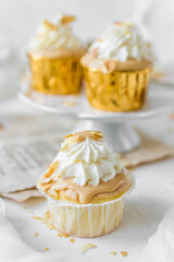 Caramel and cream cupcakes with almonds