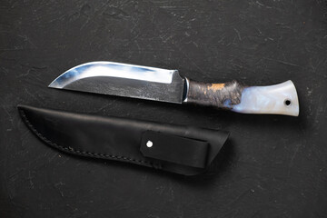 Army knife on a marching backpack background