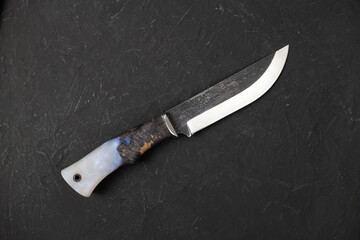 Army knife on a marching backpack background