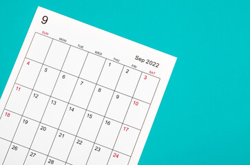 September 2022 calendar sheet on blue background.