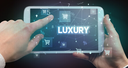 Close-up of a hand holding tablet with shopping inscription