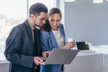 Employees in the office with a laptop